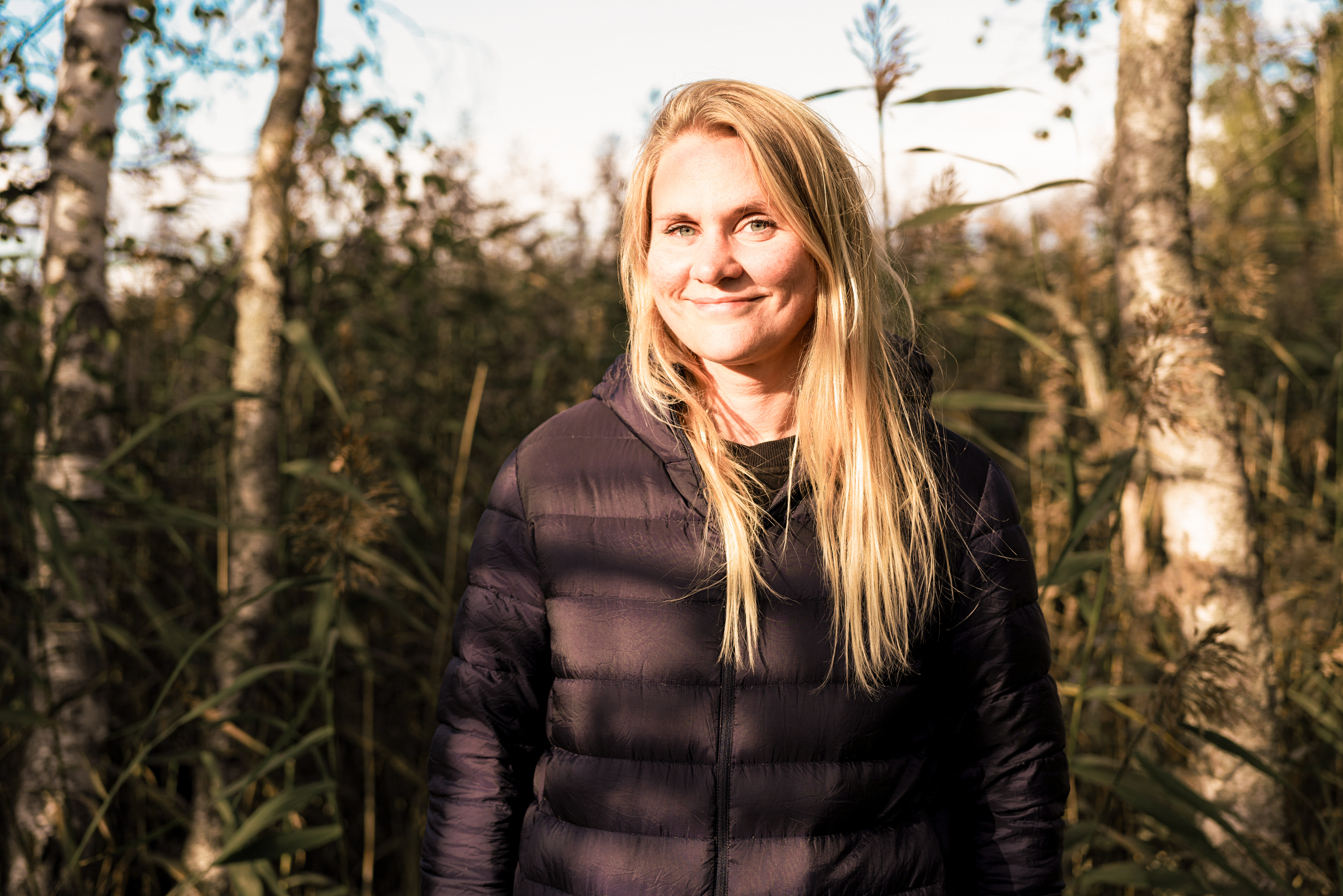 Therapist standing and smiling in front of the camera, outdoors
